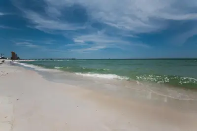a beach with the ocean and a blue sky at Sterling Breeze 307 by Emerald Coast Retreats in Panama City Beach