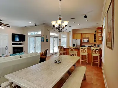 a living room with a table and a couch at The Mermaid in Rosemary Beach