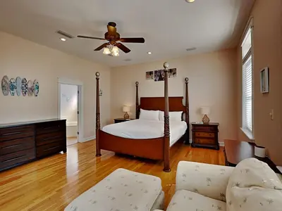 a bedroom with a bed and a ceiling fan at The Mermaid in Rosemary Beach