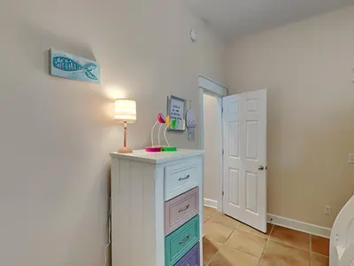 a room with a dresser with a lamp on it at The Mermaid in Rosemary Beach