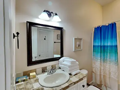 a bathroom with a sink and a mirror at The Mermaid in Rosemary Beach