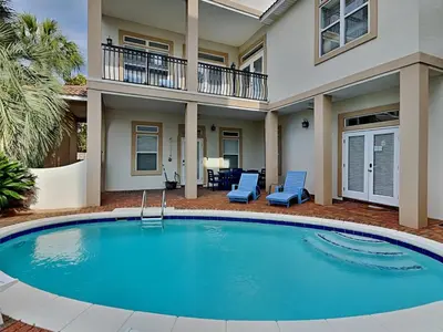 a large swimming pool in front of a house at The Mermaid in Rosemary Beach