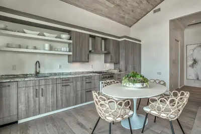 a kitchen with a white table and chairs at Love Shack in Inlet Beach