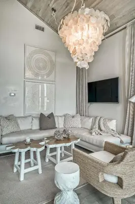 a living room with a couch and a chandelier at Love Shack in Inlet Beach