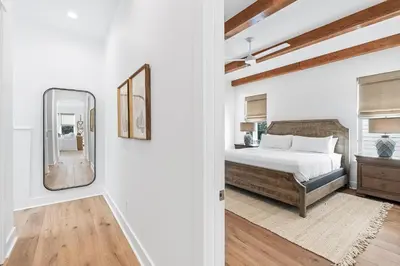 a bedroom with a bed and a mirror at Pompano In Paradise in Inlet Beach