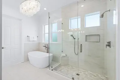 a bathroom with a tub and a shower with a glass door at Pompano In Paradise in Inlet Beach