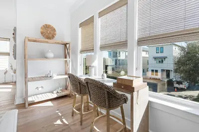 a room with a table and chairs and a window at Pompano In Paradise in Inlet Beach