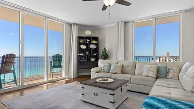 a living room with a couch and a table at Gulf-Front PCB Condo w Balcony Resort Amenities Game Room Pools Beach Gear Tortuga 1301 by AvantStay in Panama City Beach