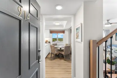 a hallway with a door leading to a dining room at Sunshine at PP A-914 in Panama City Beach