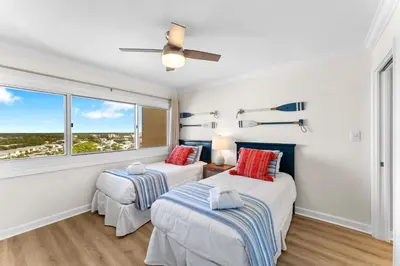 two beds in a room with a window at Sunshine at PP A-914 in Panama City Beach