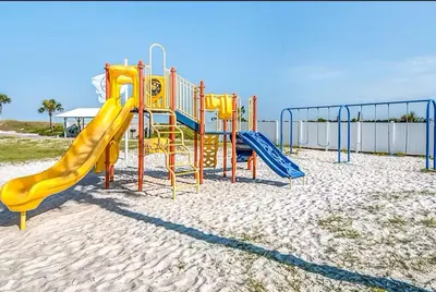 a playground with a slide on the beach at Sunshine at PP A-914 in Panama City Beach