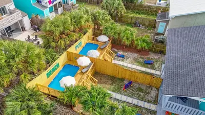 an overhead view of a water slide at a resort at Disco Dolphin – Your Funky Beachside Haven in PCB in Panama City Beach