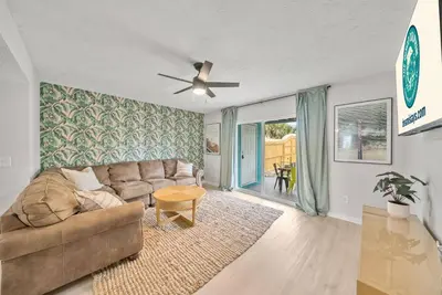 a living room with a couch and a ceiling fan at Pool + Games + Outdoor Dining + Walk to the Beach in Panama City Beach