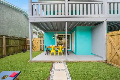a patio with a table and chairs in a yard at Pool + Games + Outdoor Dining + Walk to the Beach in Panama City Beach