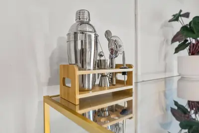 a wooden stand with a blender on a shelf at Pool + Games + Outdoor Dining + Walk to the Beach in Panama City Beach