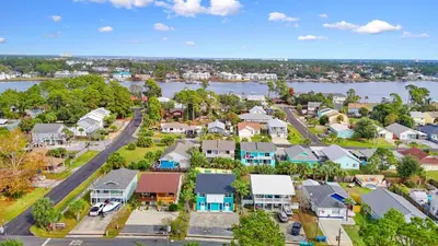 an aerial view of a town with a river and houses at Pool + Games + Outdoor Dining + Walk to the Beach in Panama City Beach