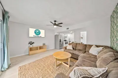 a living room with a couch and a table at Disco Dolphin Compound | 2x PCB Private Retreats! in Panama City Beach
