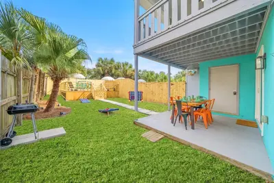 a patio with a table and chairs and a grill at Disco Dolphin Compound | 2x PCB Private Retreats! in Panama City Beach