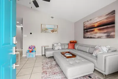 a living room with a couch and a table at Sunset Retreat TOO - 2BR - 4 Min Walk to Beach in Panama City Beach