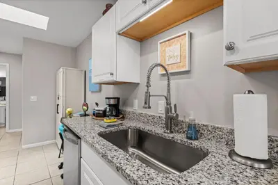 a kitchen with a sink and a counter top at 4 Min Walk to Sand - 2BR - King Bed - Private Yard in Panama City Beach