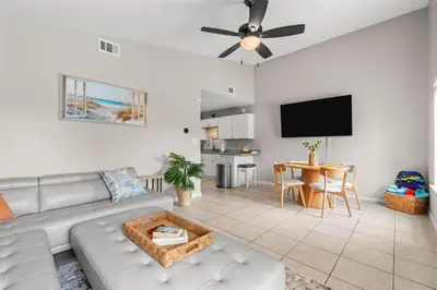 a living room with a couch and a flat screen tv at 4 Min Walk to Sand - 2BR - King Bed - Private Yard in Panama City Beach