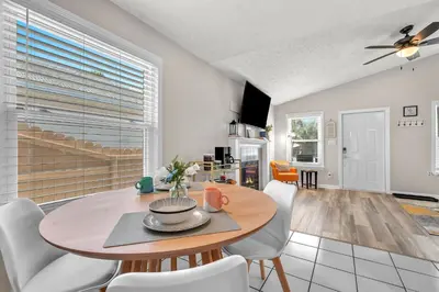 a dining room and living room with a table and chairs at Sunset Dreams TOO - King Bed - 5 Min Walk to Beach in Panama City Beach