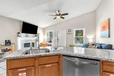 a kitchen with a sink and a ceiling fan at Sunset Dreams TOO - King Bed - 5 Min Walk to Beach in Panama City Beach