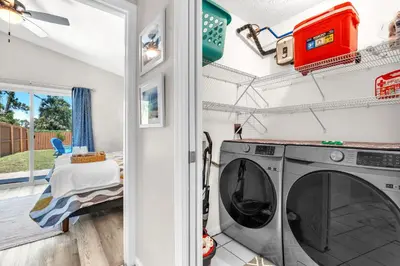 a laundry room with a washer and dryer at Sunset Dreams TOO - King Bed - 5 Min Walk to Beach in Panama City Beach