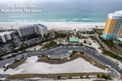 a view of the beach and buildings at risk sister park right across the street at Sunset Dreams TOO - King Bed - 5 Min Walk to Beach in Panama City Beach