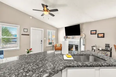 a kitchen with a sink and a ceiling fan at Sunset Dreams - King Bed - 5 Min Walk to Beach in Panama City Beach