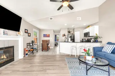a living room with a blue couch and a fireplace at Sunset Dreams - King Bed - 5 Min Walk to Beach in Panama City Beach