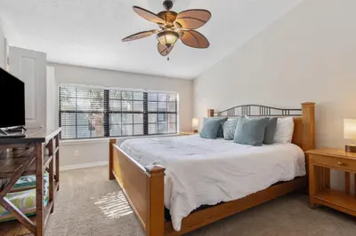 a bedroom with a bed and a ceiling fan at Family Ready 3BR 2.5BA Home, Near Parks, Shops And Beach in Panama City Beach