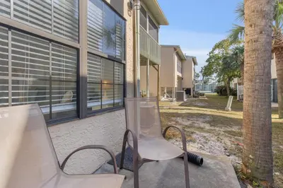 two chairs sitting in front of a building at Family Ready 3BR 2.5BA Home, Near Parks, Shops And Beach in Panama City Beach