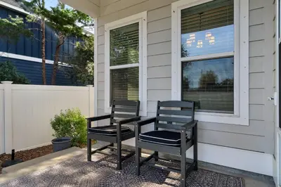 two chairs sitting on the front porch of a house at Sunlit Sands in Inlet Beach