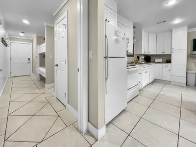 a kitchen with white cabinets and white appliances at Inlet Dunes 101 l Community Pool l Across From The Beach in Inlet Beach