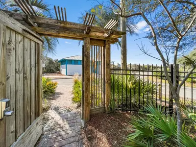 an entrance to a wooden fence with a wooden gate at Inlet Dunes 101 l Community Pool l Across From The Beach in Inlet Beach
