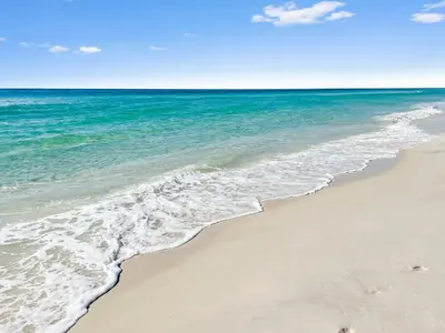 a sandy beach with the ocean in the background at Inlet Dunes 101 l Community Pool l Across From The Beach in Inlet Beach
