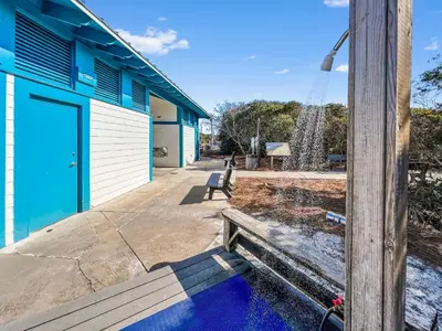 a blue and white building with a blue door at Inlet Dunes 105 l Community Pool l Across From The Beach in Inlet Beach