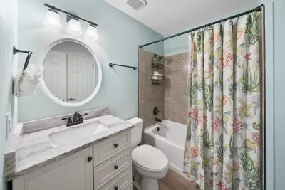 a bathroom with a sink and a shower curtain at Inlet Dunes 105 l Community Pool l Across From The Beach in Inlet Beach