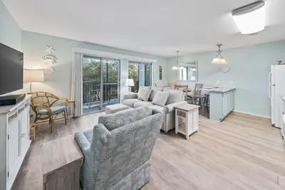 a living room with a couch and a dining room at Inlet Dunes 105 l Community Pool l Across From The Beach in Inlet Beach