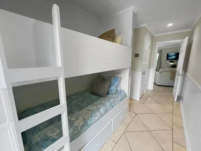 a white room with a bunk bed in it at Inlet Dunes 201 l Community Pool l Across From The Beach in Inlet Beach