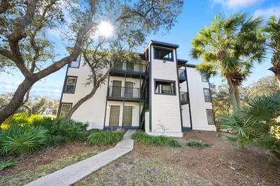 a large white house with trees in front of it at Inlet Dunes 201 l Community Pool l Across From The Beach in Inlet Beach