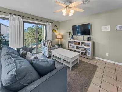 a living room with a couch and a tv at Inlet Dunes 204 l Community Pool l Across From The Beach in Inlet Beach