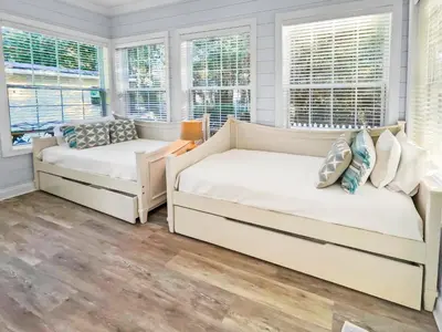 two beds in a room with windows at Keylime Pie l Heated Pool l 2 min walk to beach l 6 seater golf cart and 4 bikes included in Inlet Beach