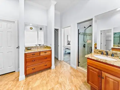 a bathroom with two sinks and a shower at Keylime Pie l Heated Pool l 2 min walk to beach l 6 seater golf cart and 4 bikes included in Inlet Beach