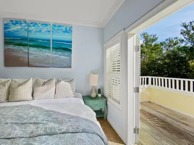 a bedroom with a bed and a balcony at Keylime Pie l Heated Pool l 2 min walk to beach l 6 seater golf cart and 4 bikes included in Inlet Beach