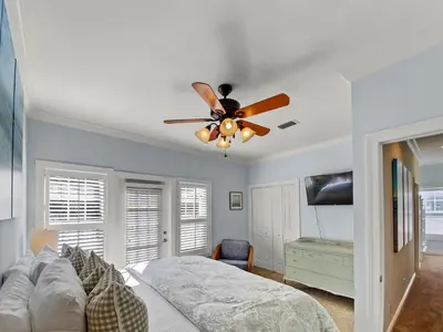 a bedroom with a ceiling fan and a bed at Keylime Pie l Heated Pool l 2 min walk to beach l 6 seater golf cart and 4 bikes included in Inlet Beach