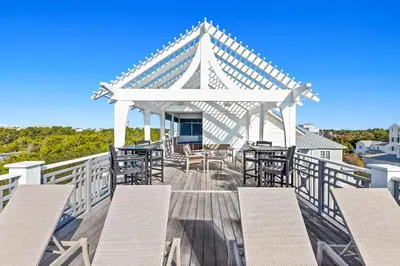 a gazebo with chairs and tables on a deck at Pomp in Paradise in Inlet Beach