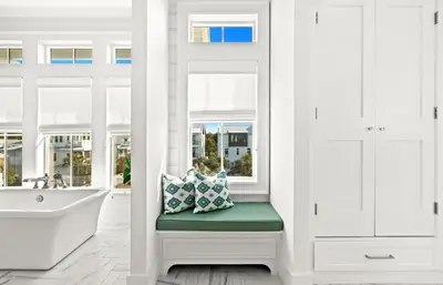 a window seat with pillows in a bathroom with a tub at Pomp in Paradise in Inlet Beach