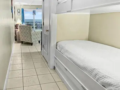 a bedroom with a bed and a view of the ocean at Leeward II 3 l Beachfront Condo l Large first level deck with steps down to sand in Seagrove Beach